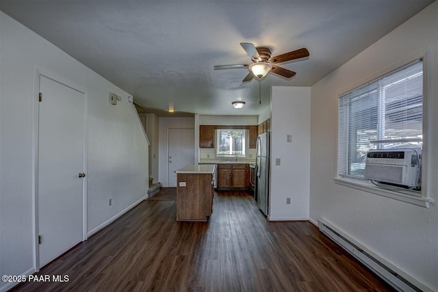 1242 Stetson Rd Unit 21, Prescott, AZ 86303 - kitchen featuring a baseboard radiator, freestanding refrigerator, a kitchen island, a ceiling fan, and dark wood-type flooring