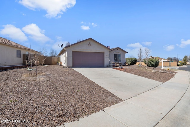 single story home featuring stucco siding, driveway, a garage, and fence