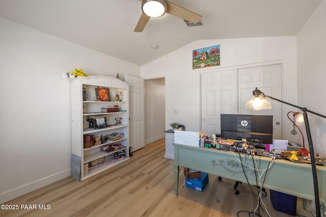 home office featuring ceiling fan, baseboards, lofted ceiling, and wood finished floors