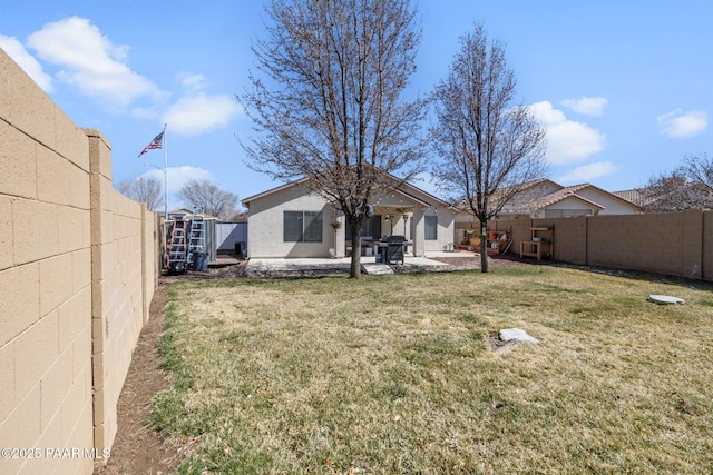 back of house featuring a patio area, a lawn, and a fenced backyard