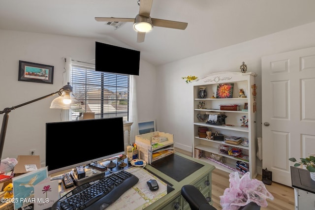 office space featuring visible vents, lofted ceiling, light wood-style floors, and a ceiling fan