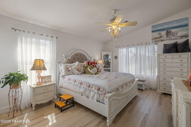 bedroom with lofted ceiling, a ceiling fan, and light wood-type flooring