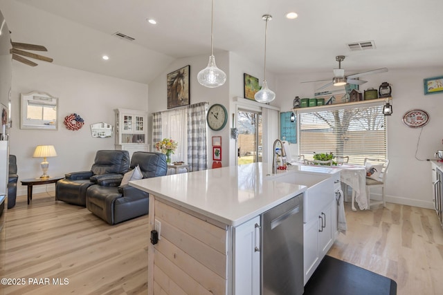 kitchen featuring visible vents, open floor plan, dishwasher, and light wood-style flooring