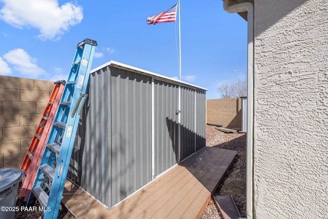 view of outbuilding with fence