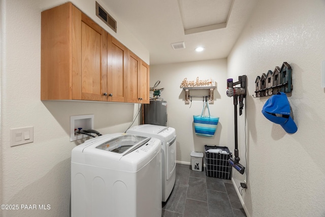laundry area with cabinet space, washing machine and clothes dryer, attic access, water heater, and visible vents