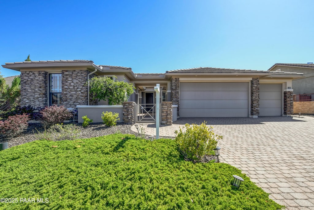 1505 Pocono Pl, Prescott, AZ 86301 - prairie-style home featuring an attached garage, decorative driveway, a tiled roof, and stone siding