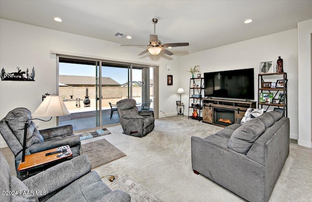 living room featuring ceiling fan and light colored carpet