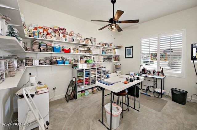 carpeted office space featuring ceiling fan