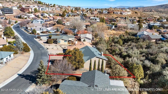 birds eye view of property with a mountain view