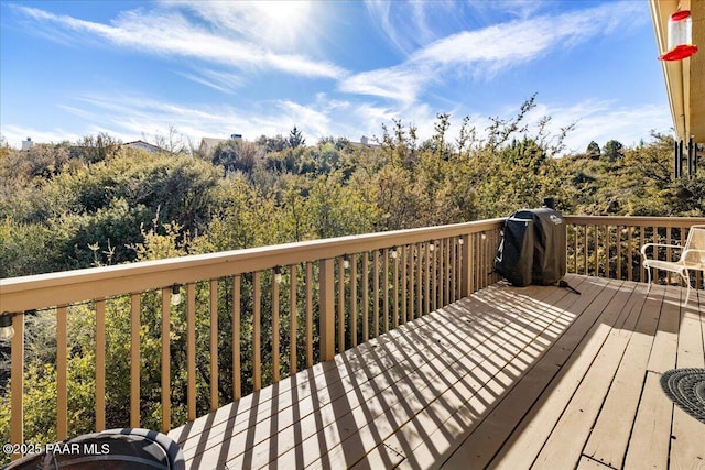 wooden terrace with a grill