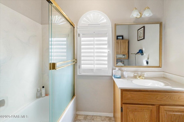 bathroom featuring vanity and bath / shower combo with glass door