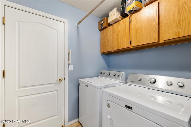 laundry area featuring cabinets and washing machine and dryer