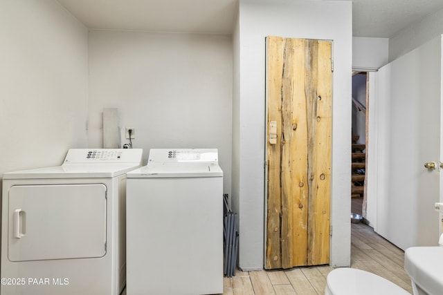 washroom with washing machine and clothes dryer