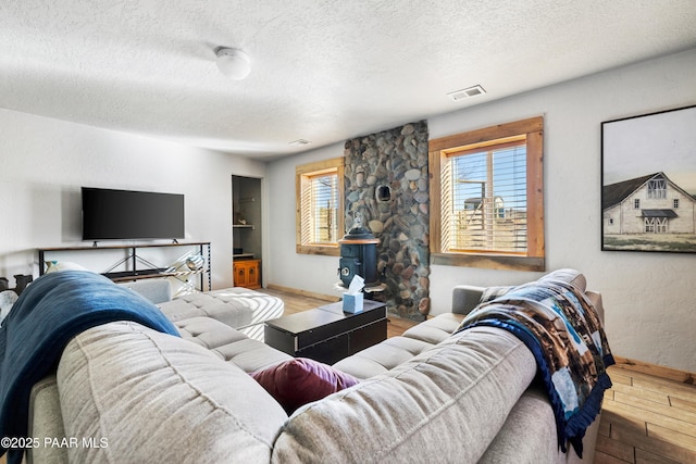 living room featuring hardwood / wood-style floors and a textured ceiling