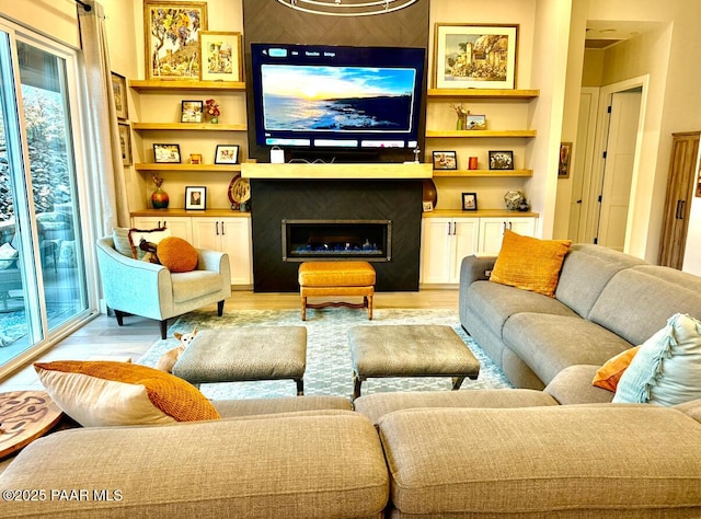 living area featuring a fireplace and light wood-style floors