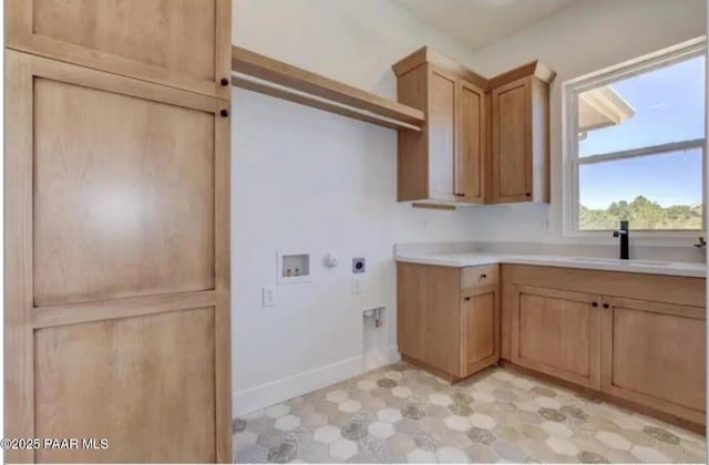 washroom featuring washer hookup, a sink, electric dryer hookup, baseboards, and light floors