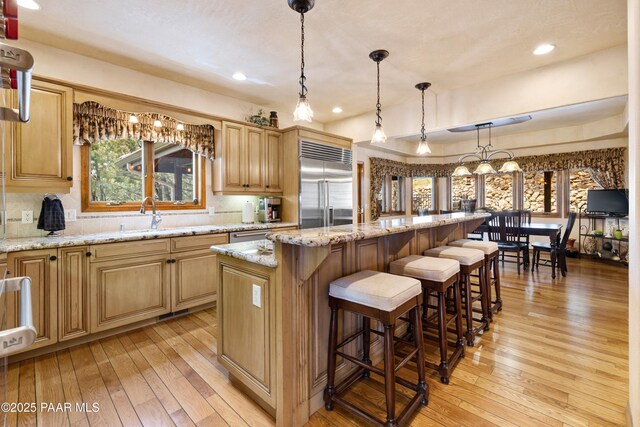 1515 N Happy Valley Rd Unit 3 & 4, Prescott, AZ 86305 - kitchen with stainless steel built in refrigerator, light wood-style floors, a kitchen island, tasteful backsplash, and light stone countertops