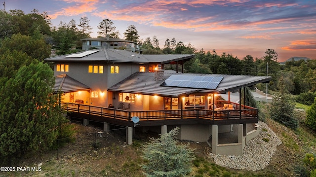 1515 N Happy Valley Rd Unit 3 & 4, Prescott, AZ 86305 - back of house at dusk with solar panels, a deck, and stucco siding