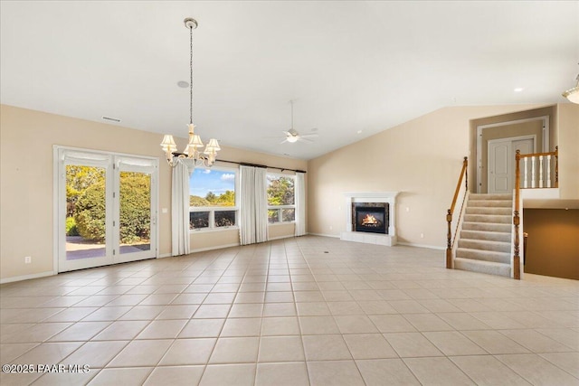 13375 N Iron Hawk Dr, Prescott, AZ 86305 - unfurnished living room with light tile patterned floors, baseboards, vaulted ceiling, stairway, and a glass covered fireplace