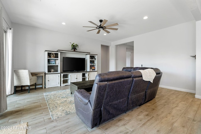 living room with ceiling fan and light hardwood / wood-style flooring