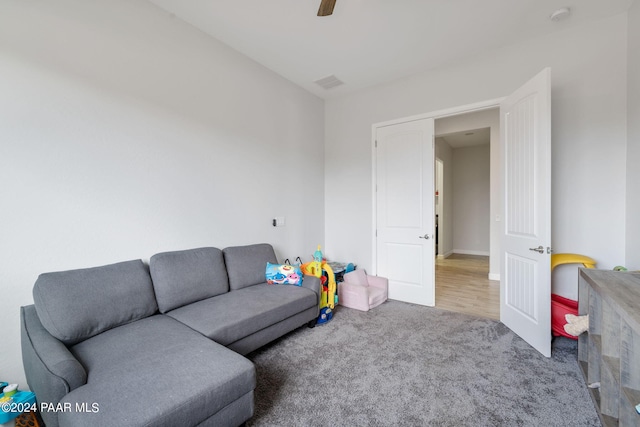 carpeted living room featuring ceiling fan