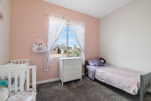 bedroom featuring dark carpet