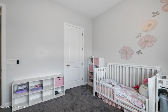 carpeted bedroom featuring a nursery area