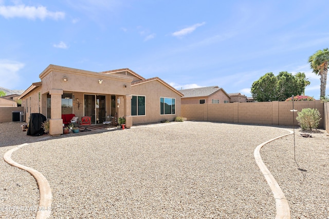 1819 W Deer Creek Rd, Phoenix, AZ 85045 - rear view of house with stucco siding and a fenced backyard