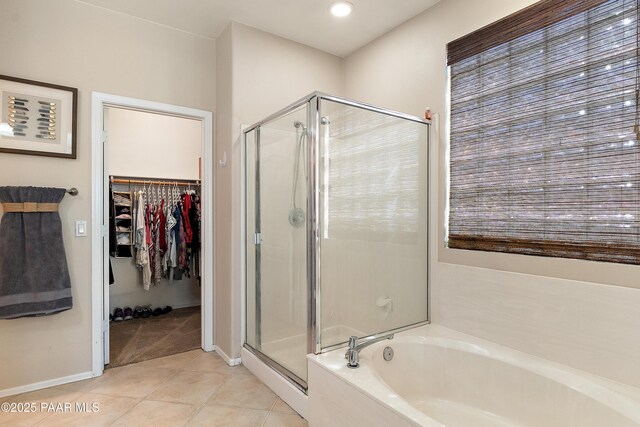 1819 W Deer Creek Rd, Phoenix, AZ 85045 - bathroom featuring a shower stall, a garden tub, tile patterned flooring, a spacious closet, and baseboards