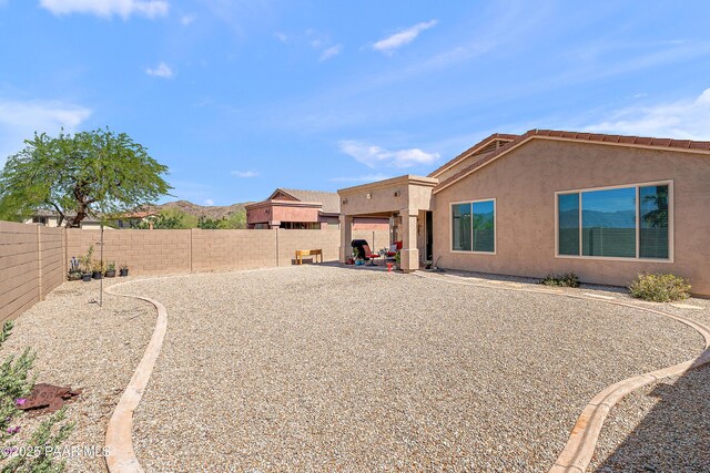 1819 W Deer Creek Rd, Phoenix, AZ 85045 - rear view of property with a fenced backyard and stucco siding
