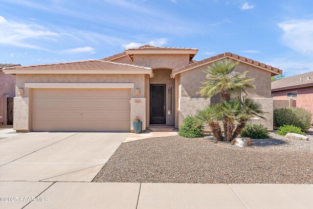 1819 W Deer Creek Rd, Phoenix, AZ 85045 - mediterranean / spanish-style house featuring driveway, a garage, and stucco siding