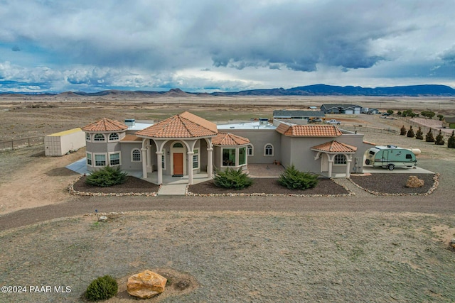 mediterranean / spanish house featuring a mountain view and covered porch