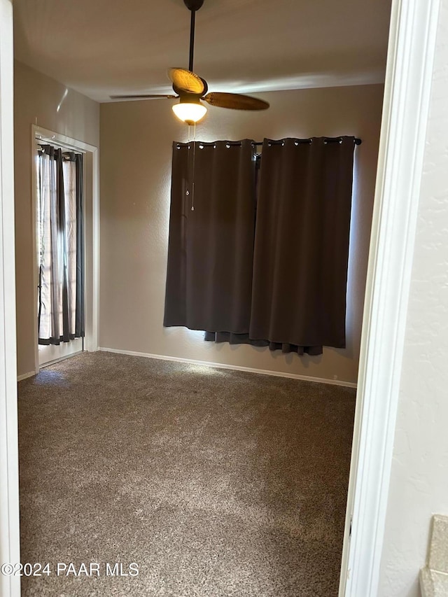 carpeted empty room with ceiling fan