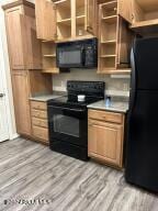 kitchen featuring light hardwood / wood-style flooring and black appliances