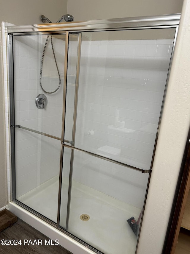 bathroom featuring hardwood / wood-style floors and walk in shower