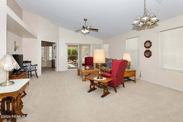 living room with ceiling fan with notable chandelier, light colored carpet, and lofted ceiling