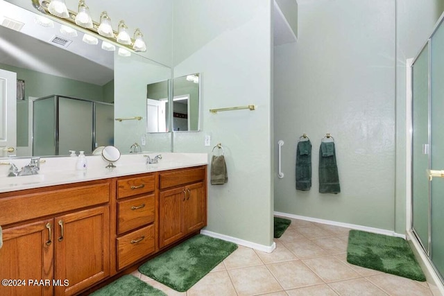 bathroom featuring tile patterned flooring, vanity, and an enclosed shower