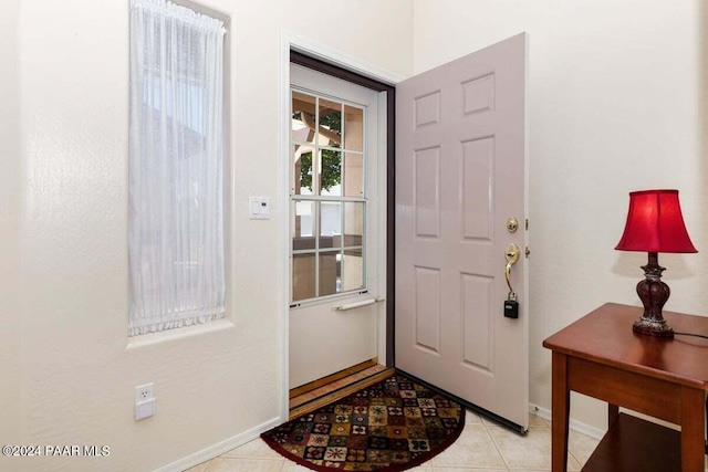 entryway with light tile patterned floors