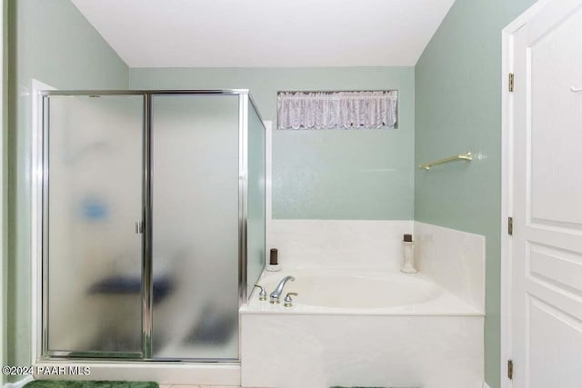 bathroom featuring shower with separate bathtub