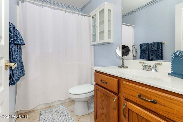 bathroom featuring toilet, vanity, and tile patterned floors