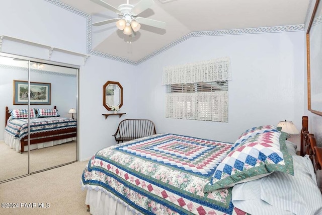 bedroom featuring ceiling fan, a closet, carpet floors, and vaulted ceiling