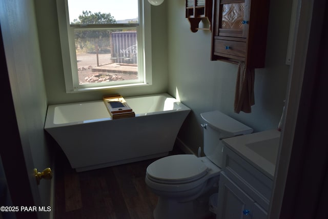 25633 W El Dorado Dr, Seligman, AZ 86337 - bathroom with vanity, a freestanding tub, toilet, and wood finished floors