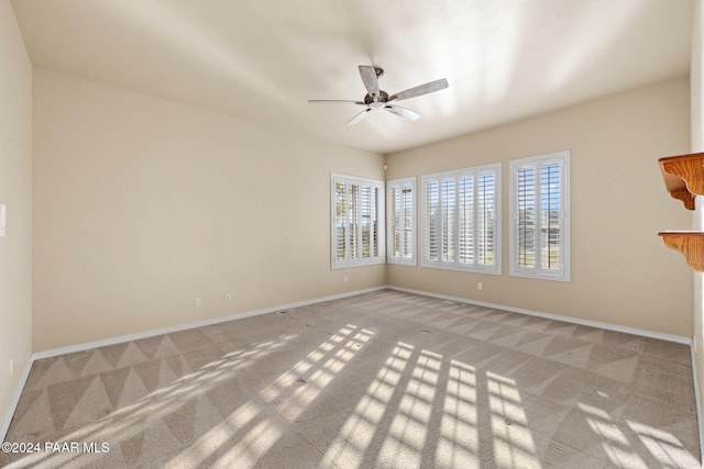 empty room with ceiling fan and light colored carpet