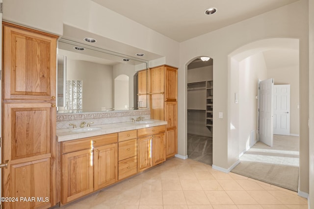 bathroom featuring tile patterned flooring and vanity