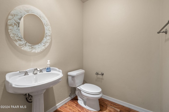 bathroom featuring hardwood / wood-style floors and toilet