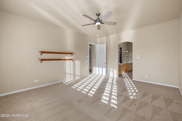 interior space with carpet floors and ceiling fan