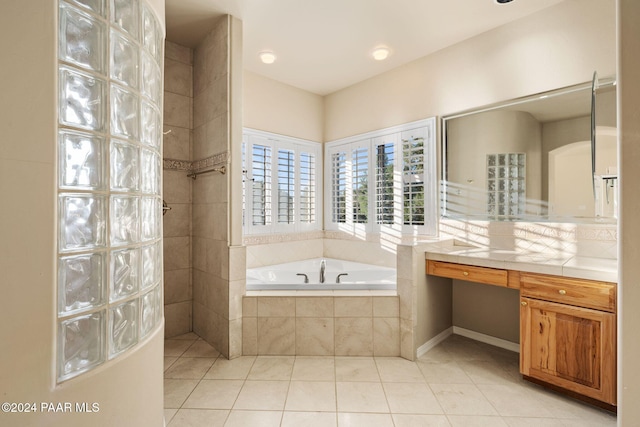 bathroom with vanity, tiled bath, and tile patterned floors