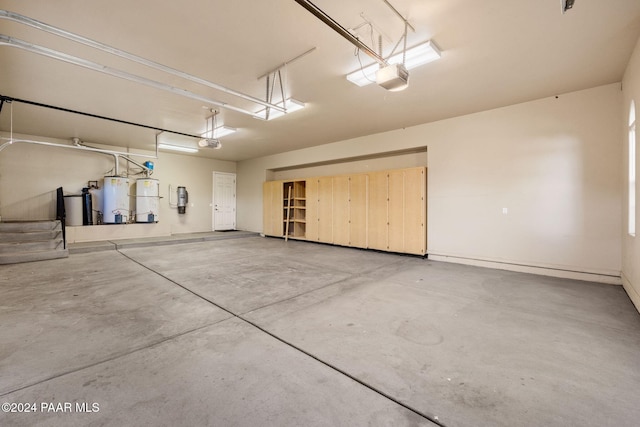 garage featuring a garage door opener and water heater