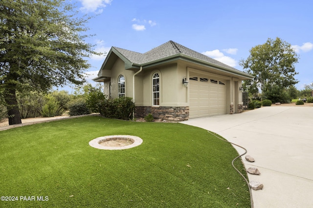 view of front of home featuring a garage and a front lawn