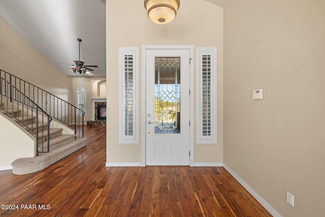 foyer entrance featuring ceiling fan and dark wood-type flooring